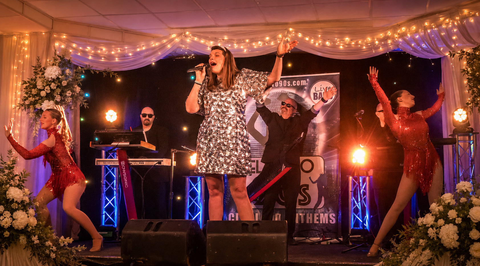 Electro 90s performing with singers, musicians and dancers at a wedding reception